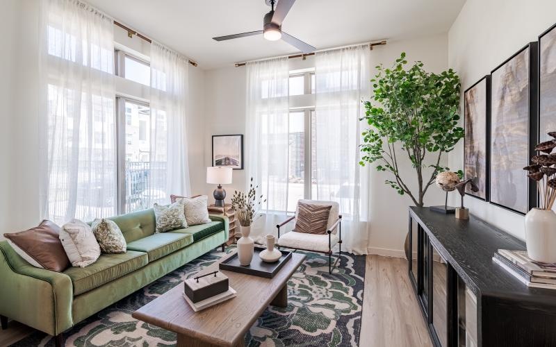a living room with a green couch and a coffee table