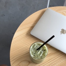 a computer and drink on a table