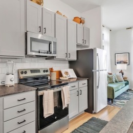 a kitchen with grey cabinets
