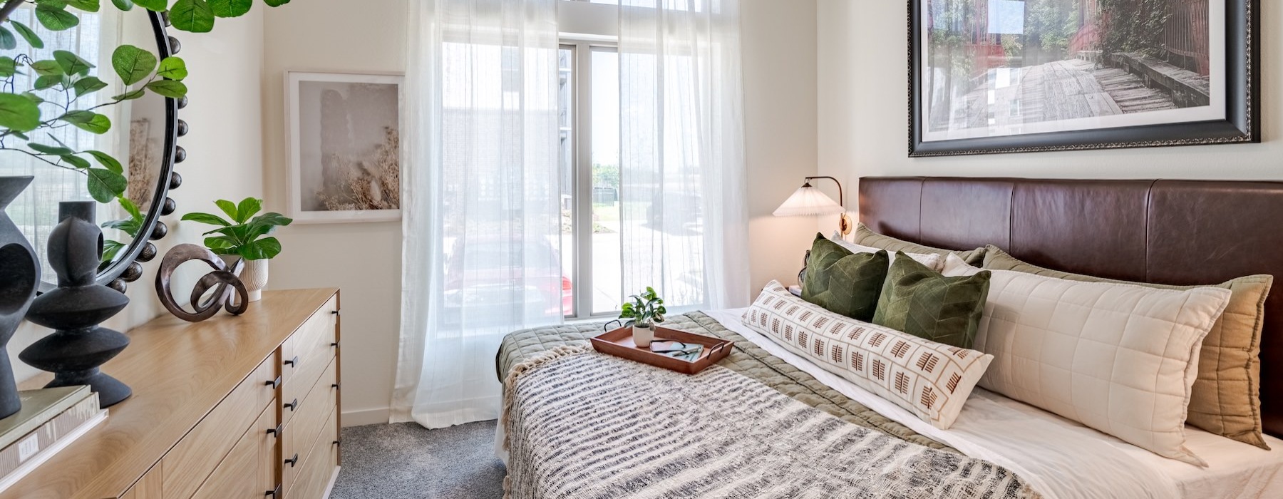 a bedroom with a bed and a plant