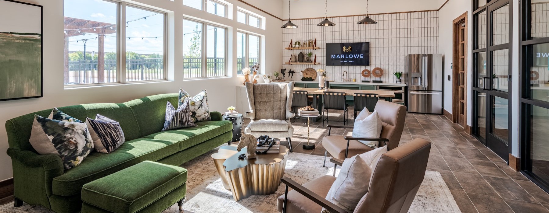 a clubroom with a couch, chairs and a tv