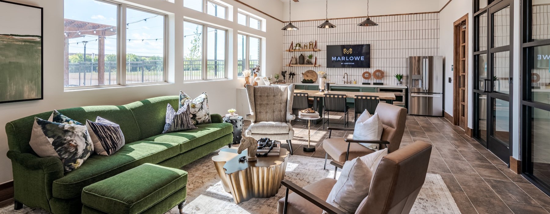 a clubroom with a couch, chairs and a tv