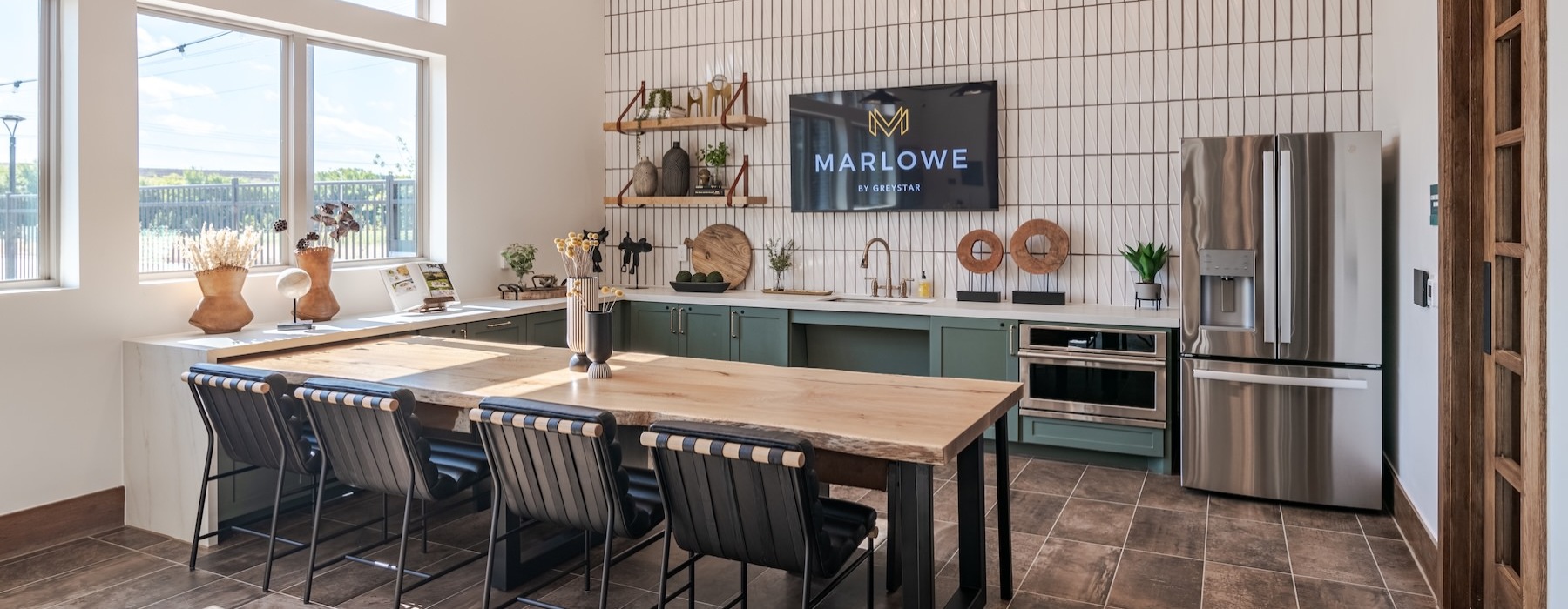 a kitchen with a bar and chairs