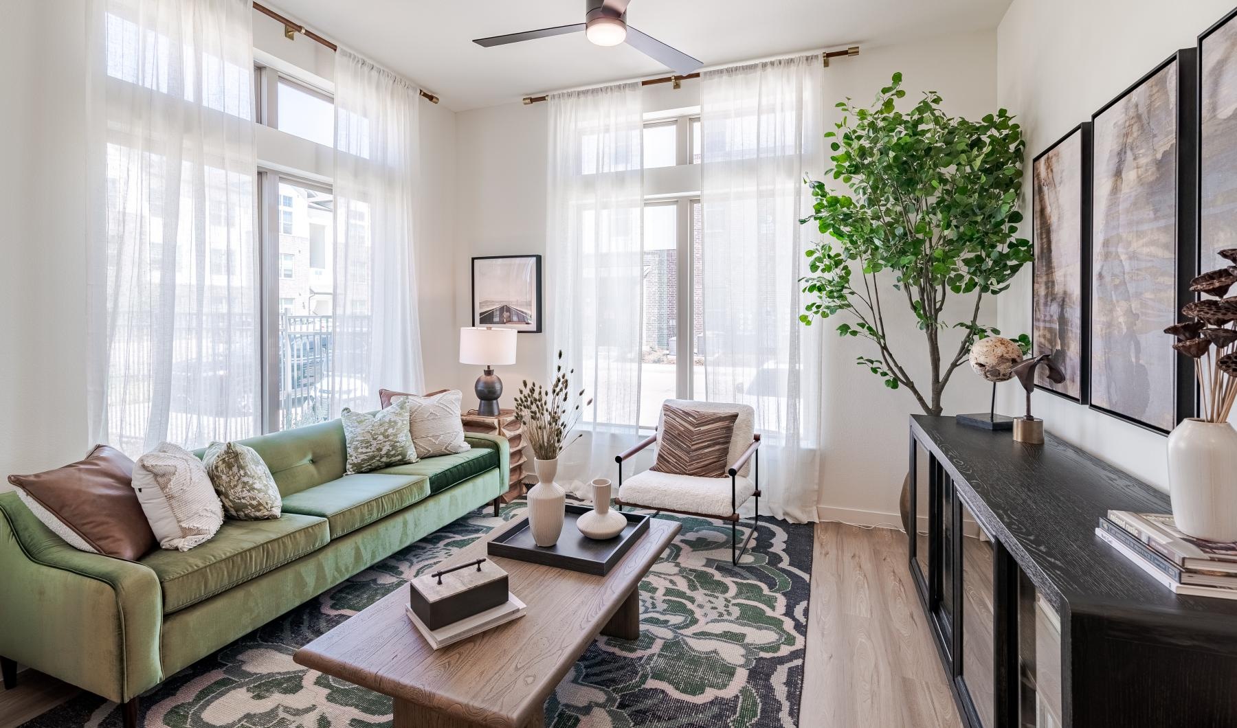 a living room with a green couch and a coffee table
