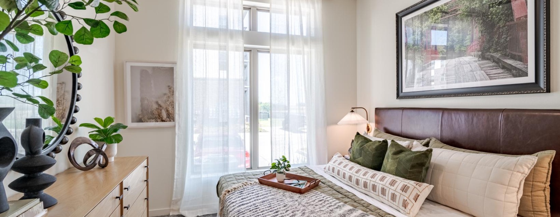 a bedroom with a bed and a plant